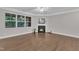 Bright living room featuring a fireplace, large window, ceiling fan, and hardwood floors at 2073 Weston Green Loop, Cary, NC 27513