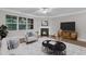 Staged living room with hardwood floors features a fireplace and a large window for optimal natural lighting at 2073 Weston Green Loop, Cary, NC 27513