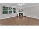 Open living room with hardwood floors features a cozy fireplace and large windows for optimal natural lighting at 2073 Weston Green Loop, Cary, NC 27513