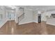 Spacious open floor plan featuring hardwood floors, a staircase, and modern kitchen appliances at 2073 Weston Green Loop, Cary, NC 27513
