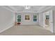 Expansive main bedroom with plush carpet, tray ceiling, and bright windows offers serene retreat with space and light at 2073 Weston Green Loop, Cary, NC 27513