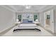 Stylish main bedroom boasts tray ceilings, abundant natural light, and a soothing color palette to promote relaxation at 2073 Weston Green Loop, Cary, NC 27513