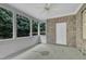 Enclosed sunroom featuring brick accent wall and large windows overlooking lush backyard at 2073 Weston Green Loop, Cary, NC 27513