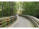 Wooden walking path through lush forest, perfect for enjoying nature at 2073 Weston Green Loop, Cary, NC 27513