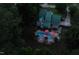 Overhead view of a home with a green metal roof and in-ground pool with red umbrellas and patio area at 213 Birch Creek Dr, Fuquay Varina, NC 27526