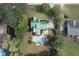 Aerial view of a home with a green roof and in-ground pool surrounded by trees and manicured lawns at 213 Birch Creek Dr, Fuquay Varina, NC 27526