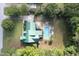 Aerial view of a home with a lush yard, a swimming pool, and a green metal roof at 213 Birch Creek Dr, Fuquay Varina, NC 27526
