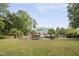 Large backyard with a pool area, mature trees, and landscaping at 213 Birch Creek Dr, Fuquay Varina, NC 27526