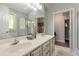 Bright bathroom featuring double sinks, a large mirror, and a view into the closet at 213 Birch Creek Dr, Fuquay Varina, NC 27526
