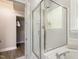 Bright bathroom with a glass enclosed shower adjacent to a soaking tub and closet access at 213 Birch Creek Dr, Fuquay Varina, NC 27526