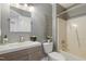 Gray bathroom featuring a single sink, tub, and toilet at 213 Birch Creek Dr, Fuquay Varina, NC 27526