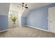 Blue bedroom with white pitched ceilings, carpeted floors, and a large window at 213 Birch Creek Dr, Fuquay Varina, NC 27526