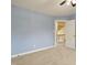 Bedroom with light blue walls, carpeted floor, and an open door at 213 Birch Creek Dr, Fuquay Varina, NC 27526