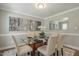 This dining room features a glass-topped table with seating for six, plus elegant wall decor and neutral colors at 213 Birch Creek Dr, Fuquay Varina, NC 27526