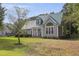 Beautiful single-Gathering home featuring a green metal roof, landscaped lawn, and inviting front porch at 213 Birch Creek Dr, Fuquay Varina, NC 27526