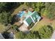 Exterior elevation of home with green roof, large backyard and patio, and circular driveway at 213 Birch Creek Dr, Fuquay Varina, NC 27526