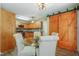 This kitchen features wooden cabinets and stainless steel appliances, plus a breakfast nook with a barn door at 213 Birch Creek Dr, Fuquay Varina, NC 27526
