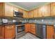 This modern kitchen offers stainless steel appliances, granite countertops, stone backsplash, and wood cabinets at 213 Birch Creek Dr, Fuquay Varina, NC 27526