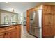 This kitchen offers stainless appliances and wooden cabinets, with an open view to the breakfast nook and living room at 213 Birch Creek Dr, Fuquay Varina, NC 27526