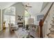 Bright living room boasts vaulted ceilings, large windows, a stone fireplace, and stylish furnishings at 213 Birch Creek Dr, Fuquay Varina, NC 27526