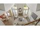 Bright living room boasts vaulted ceilings, large windows, a stone fireplace, and stylish furnishings at 213 Birch Creek Dr, Fuquay Varina, NC 27526
