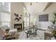 Bright living room boasts vaulted ceilings, large windows, a stone fireplace, and stylish furnishings at 213 Birch Creek Dr, Fuquay Varina, NC 27526