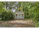 Practical backyard storage shed offering additional space for tools and equipment in a private, wooded area at 213 Birch Creek Dr, Fuquay Varina, NC 27526