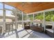 Relaxing sunroom boasts wood ceiling and backyard pool views through large windows at 213 Birch Creek Dr, Fuquay Varina, NC 27526