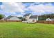 A spacious backyard featuring a patio, screened porch, and lush green lawn, perfect for outdoor activities at 22 Chapman Ct, Wendell, NC 27591