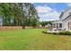 Expansive backyard with a well-maintained lawn, patio seating, and lush landscaping for outdoor enjoyment at 22 Chapman Ct, Wendell, NC 27591