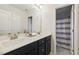 Bathroom with double sink vanity, quartz countertop, and gray floor tiles at 22 Chapman Ct, Wendell, NC 27591