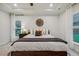 Calm bedroom with natural light, neutral colors, and windmill wall decor at 22 Chapman Ct, Wendell, NC 27591