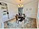Bright dining area featuring a modern chandelier, stylish rug, and elegant built-in shelving at 22 Chapman Ct, Wendell, NC 27591