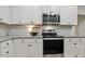 Kitchen showcases stainless steel oven and microwave, plus granite countertops and subway tile backsplash at 22 Chapman Ct, Wendell, NC 27591