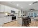 Modern kitchen featuring stainless steel appliances, subway tile backsplash, and an island with bar stools at 22 Chapman Ct, Wendell, NC 27591