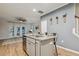 Kitchen island with seating and a view of the living room and stairway at 22 Chapman Ct, Wendell, NC 27591