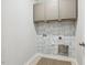 Laundry room featuring wallpaper and tile flooring at 22 Chapman Ct, Wendell, NC 27591