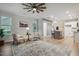 Open living area with decorous rug, kitchen island, and stylish ceiling fan at 22 Chapman Ct, Wendell, NC 27591
