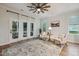 Cozy living room featuring French doors to outside, chairs, and area rug at 22 Chapman Ct, Wendell, NC 27591