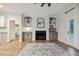 Bright living room with built-in shelving surrounding fireplace and decorative rug at 22 Chapman Ct, Wendell, NC 27591