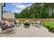 Inviting patio featuring a modern fire pit and comfortable rocking chairs with orange throw pillows at 22 Chapman Ct, Wendell, NC 27591