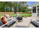 Cozy patio features a fire pit and comfortable seating amidst a lush, fenced backyard at 22 Chapman Ct, Wendell, NC 27591