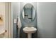 Stylish powder room with oval mirror and pedestal sink at 22 Chapman Ct, Wendell, NC 27591