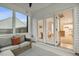 Cozy sunroom with wicker furniture, geometric rug, and views into the main house at 22 Chapman Ct, Wendell, NC 27591