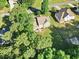 Expansive backyard, mature trees, patio with umbrella and two story home in this aerial view at 2207 Wimberly Woods Dr, Sanford, NC 27330