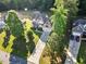 Aerial view showcasing the home's long driveway, landscaped yard, and proximity to other homes at 2207 Wimberly Woods Dr, Sanford, NC 27330