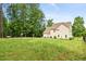 Large backyard featuring a basketball court, swing set, and manicured lawn at 2207 Wimberly Woods Dr, Sanford, NC 27330