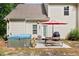 Private backyard featuring a hot tub, grill, and patio furniture with red umbrella at 2207 Wimberly Woods Dr, Sanford, NC 27330
