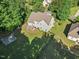 Aerial view of home with basketball court, outdoor seating area, and tree coverage at 2207 Wimberly Woods Dr, Sanford, NC 27330