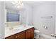Bathroom features a double sink vanity, bathtub, and neutral tones at 2207 Wimberly Woods Dr, Sanford, NC 27330